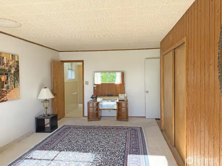 The primary bedroom looking towards the 3/4 bath. This room easily fit a California King bed with room to spare.