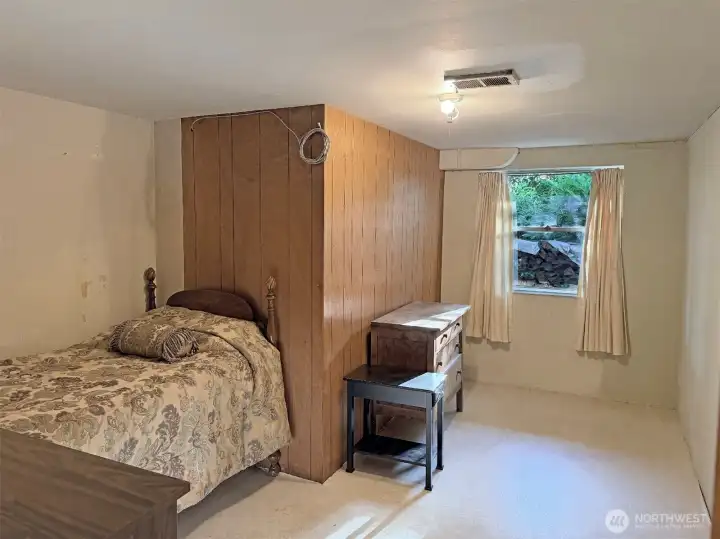 The basement den was used as a bedroom. A portable closet was outside the room. The closet is no longer in place. This could be a home office, library, craft room or anything you'd like it to be.