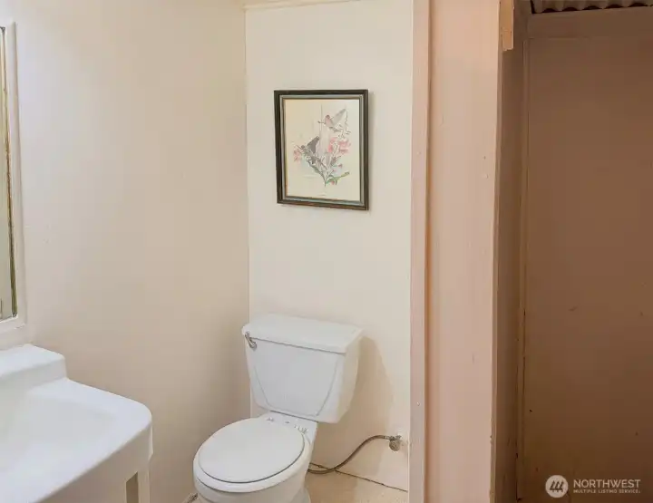 The lower level 3/4 bathroom. Currently the shower is not usable. It would be easy to expand this bathroom if you wanted to because the wall on the right side backs up to an unfinished area of the basement.