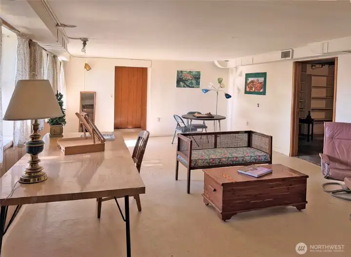 More of the large rec room. The paneling seen in the back of the photo leads to a door to the back yard.