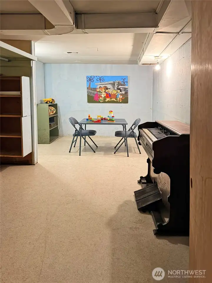 This room is located behind the fireplace in the rec room. The shelves reamain with the house. The antique pump organ, originally from St Monica's is negotiable.