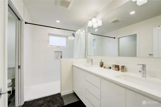 Master 3/4 bathroom with double sinks and custom tile shower. Radiant heated floor.