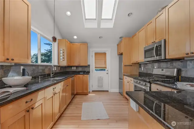 Galley kitchen with direct access to back deck and yard. Entertainers dream!