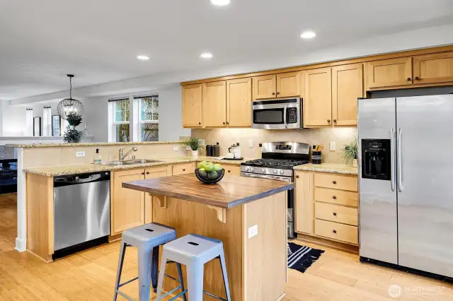 Gas range and island with breakfast bar.