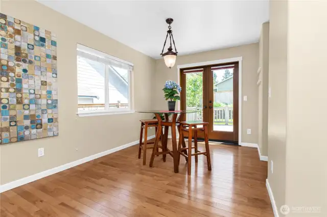 Dining area between living room and kitchen features beautiful wooden French doors!