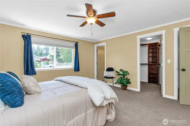 Primary bedroom features walk in closet with built-in organization shelving!