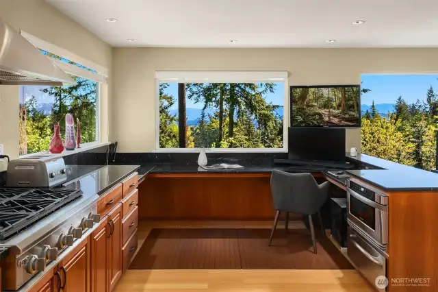 Updated over time, the kitchen offers granite surfaces, work station and stainless appliances.