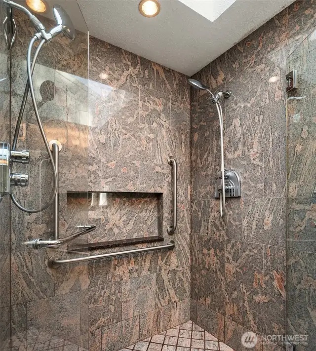 The spacious walk-in shower offers a trendy design, skylight and two showerheads.