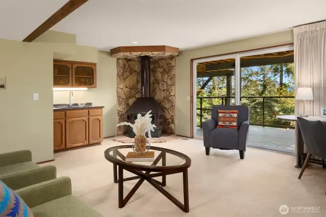 The wood-burning stone fireplace and wet bar are offered.