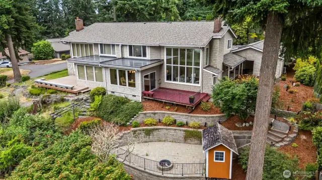 Lives like a townhouse / duplex with this unit on the right side, including the firepit area and garden shed.