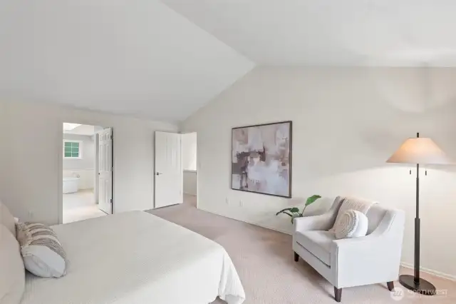 This primary suite lives large with vaulted ceilings and lots of natural light.