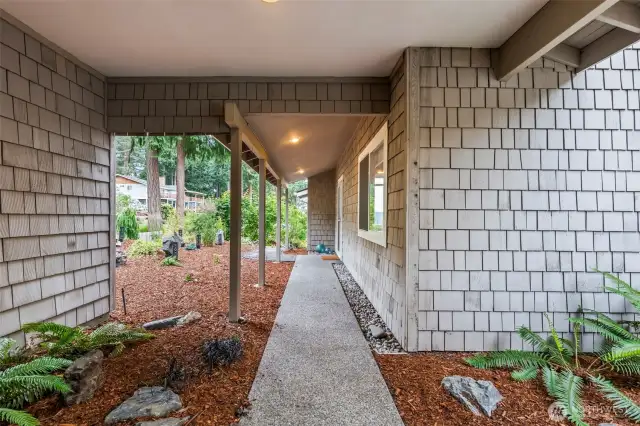 Covered walk between garages to the front door.