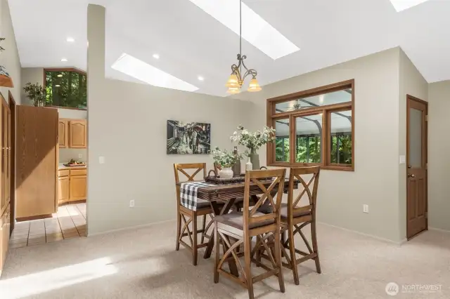 Enjoy the high ceilings and many skylights bringing in the natural light! Door from the dining room area leads to the beautiful sunroom directly off this area.