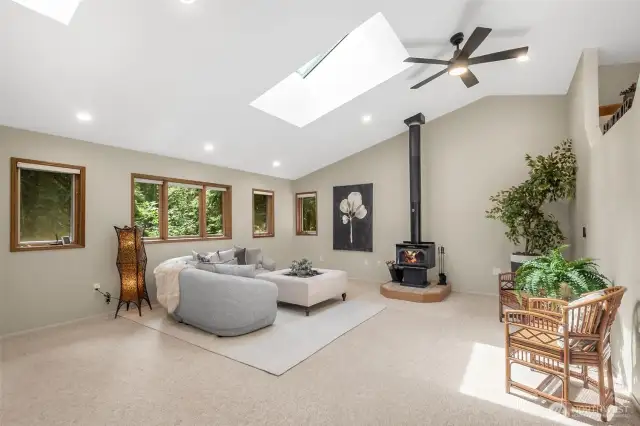 The living and dining rooms flow seamlessly together and offer a perfect environment for everyday living or entertaining, enhanced by the cozy ambiance of a wood-burning stove.