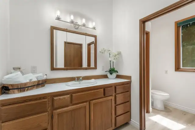 The attached full bath offers an expansive layout with a separate shower/tub and toilet area, ready for personalization to match your own style.