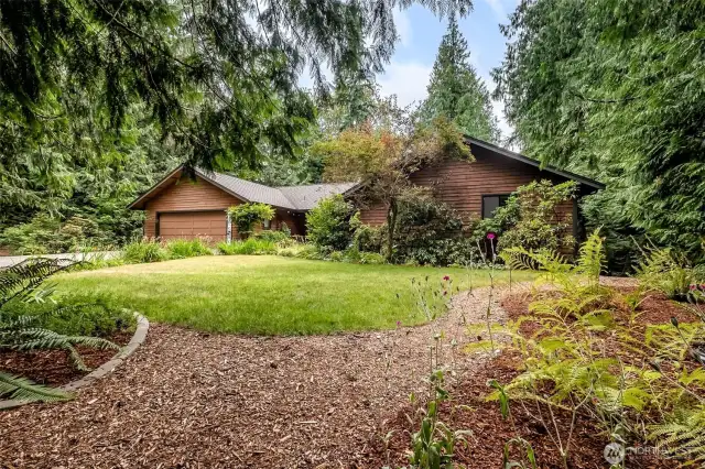 From the front yard, you can see the mature landscaping that has been developed on this property. Lots of gardening has been done through the years - add your own touch! Though you’ll enjoy the serenity of nature and the privacy of rural living, this home is surprisingly close to all the essentials. Located within the highly desirable Tahoma School District, the property offers easy access to Highway 18 and Highway 169, making commuting and errands a breeze.