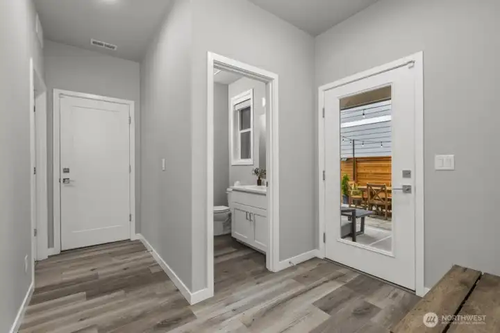 Directly after the great room you will find the powder room, the walk-in pantry on left, followed by laundry room.