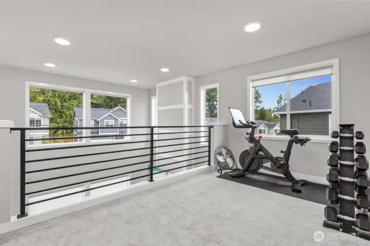 Upstairs, a versatile loft offers the perfect flex space—ideal for a home office, playroom, or media spot.
