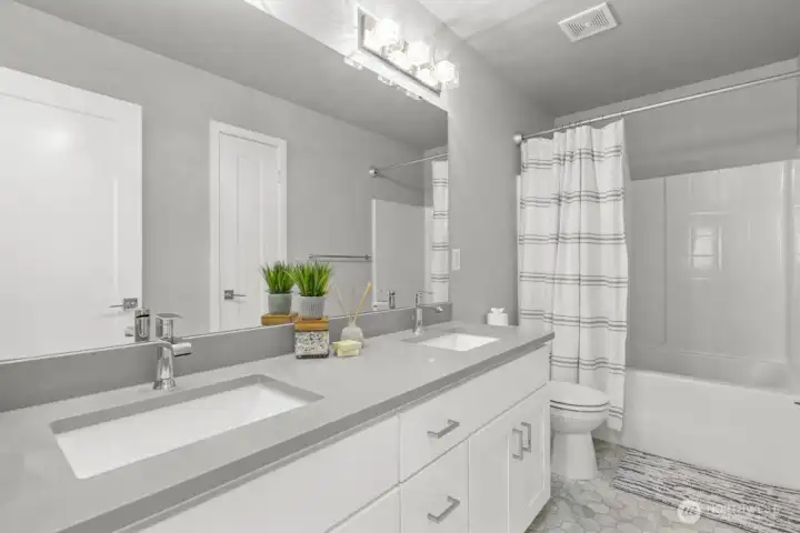 Then you will find the full bath with dual vanities and quartz counter tops.