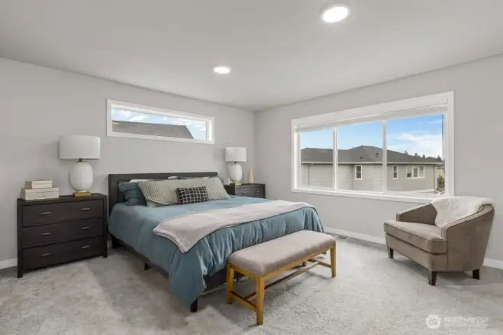 The spacious primary bed has room for all your bedroom furniture.