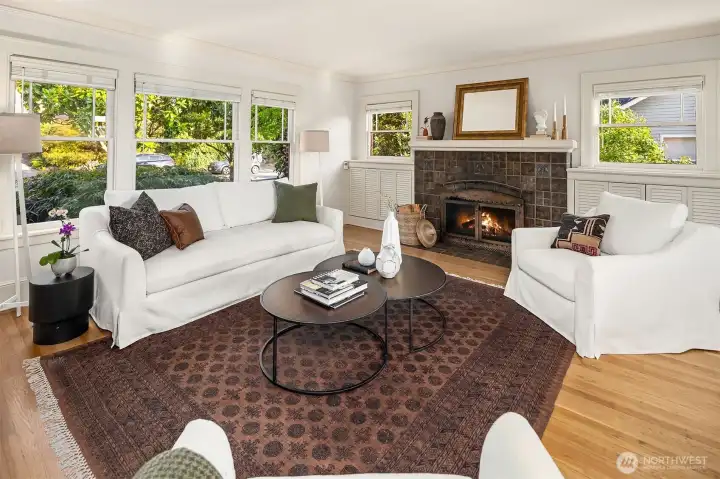 Large windows fill the spacious living room with natural light inviting the greenery of the outdoors inside.