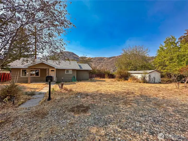 Level 9,180sf lot has plenty of parking space and concrete floor outbuilding for storage.