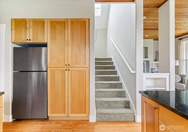 Refrigerator and more great storage. Stairs lead to two more bedrooms upstairs.