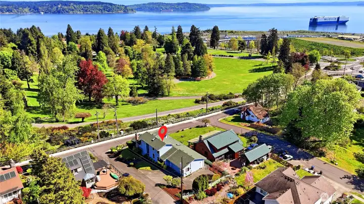 Drone photo of this serene neighborhood with water and islands beyond.