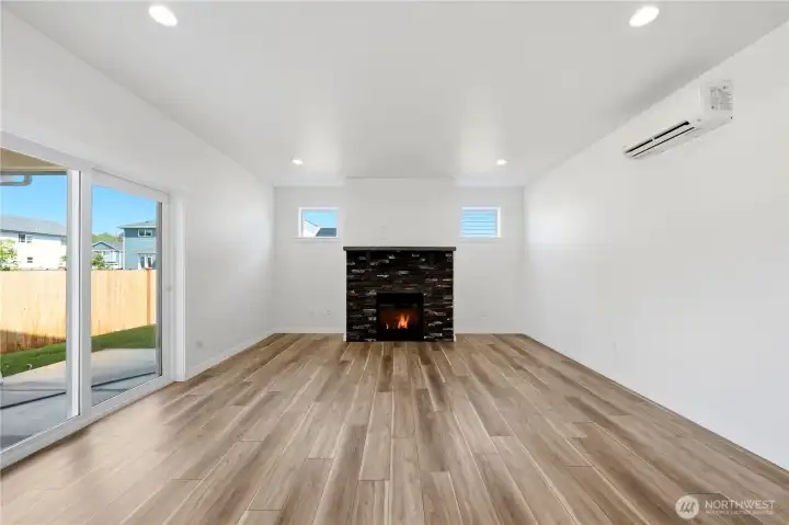 Living room with handcrafted masonry fireplace and slider to the back patio
