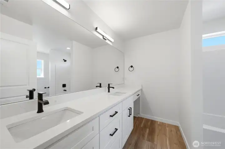 Upstairs secondary bathroom with double vanity and quartz countertops