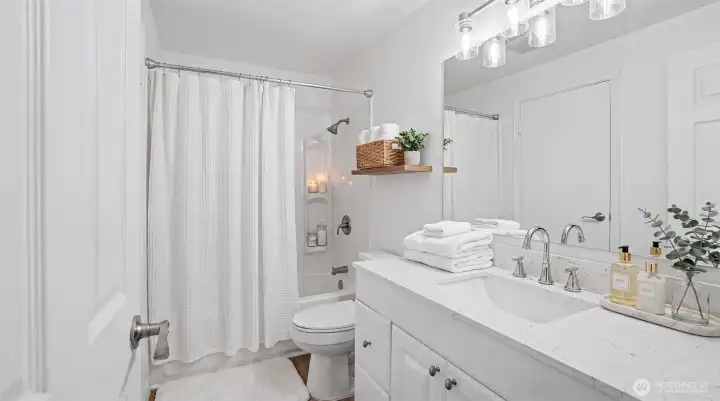 Full Bath on the Upper Level, updated in 2025 with new quartz countertop, cabinet, sink w/ faucet, LVP flooring, and light fixtures. Virtually staged. Full Bath on the Upper Level, updated in 2025 with new quartz countertop, cabinet, sink w/ faucet, LVP flooring, and light fixtures. Virtually staged.