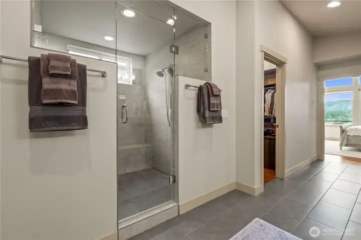 Walk in shower with dual shower heads and a bench to sit. Walk in shower with dual shower heads and a bench to sit.