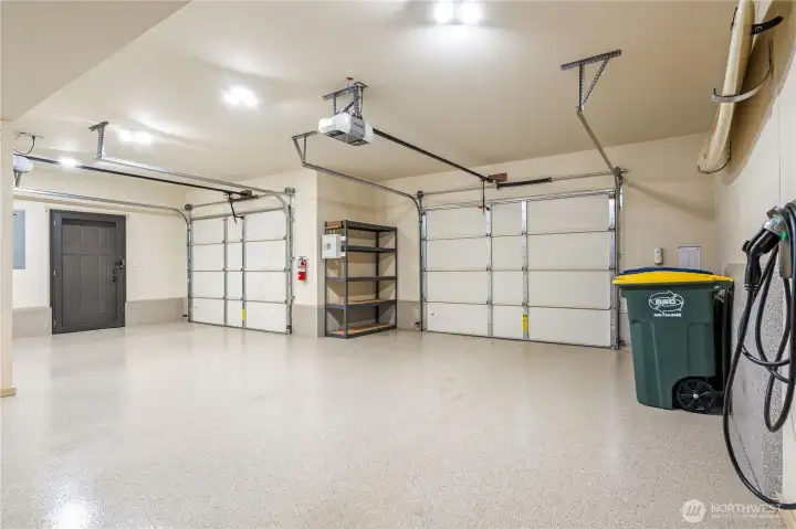 Two garage doors with two car tandem parking on the right side. Two garage doors with two car tandem parking on the right side.