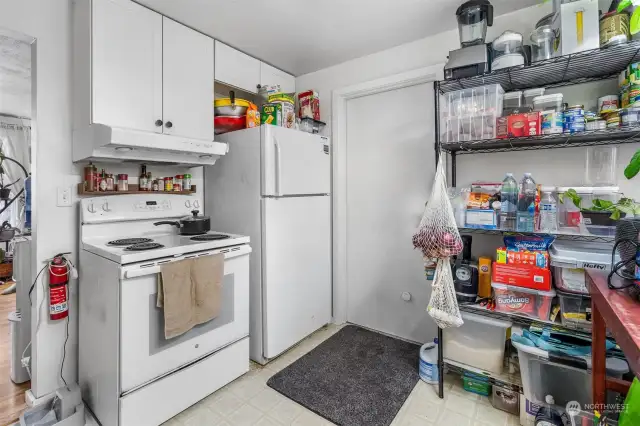 Refrigerator and stove/range stay! Doorway opens to attached garage.