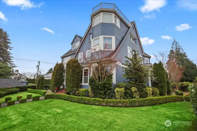 Here is the splendid McCormick mansion housing your new home in North Tacoma. The gorgeous landscaping creates a park-like feel.