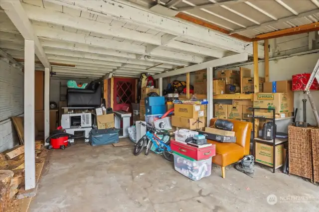 The garage is currently being used for surplus storage. there is plenty of room for a car. The red door seen toward the back opens to a wine cellar.