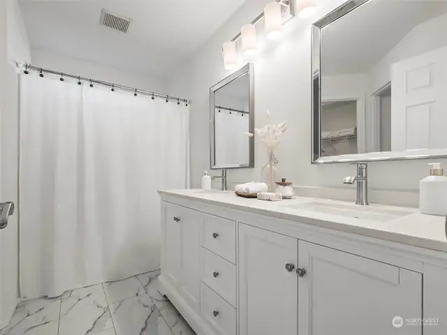 En suite has brand new vanity, flooring and lighting.