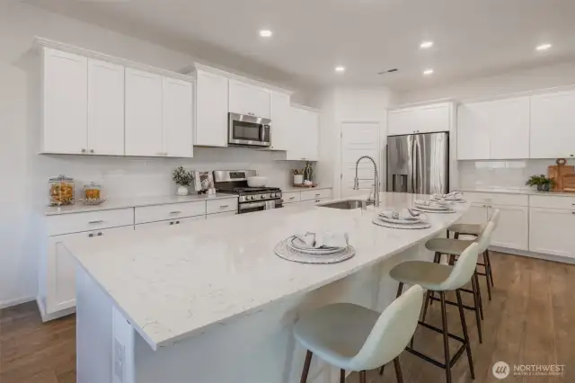 Large Kitchen with Quartz Countertops emphasized by a grand island