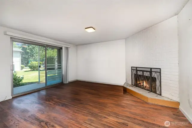 Living room features a large sliding door that fills the space with natural light and provides easy access to the outdoors.