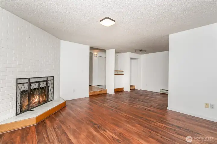 Living room features a cozy corner fireplace, adding warmth and charm to the space.