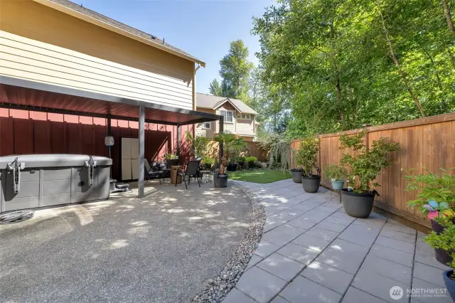 Stone pavers outline the concrete patio as an extension; perfect for container gardening.