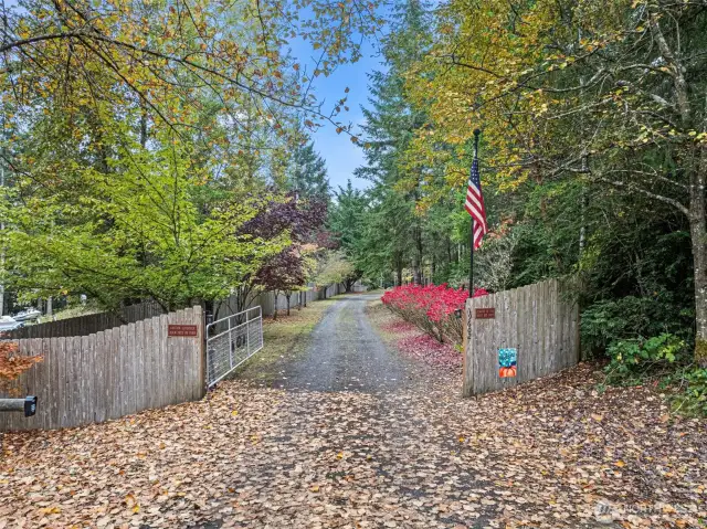Electronic gate with keypad & remote greets you as you arrive at this amazing property.  Drive is lined with mature landscaping for year round color.