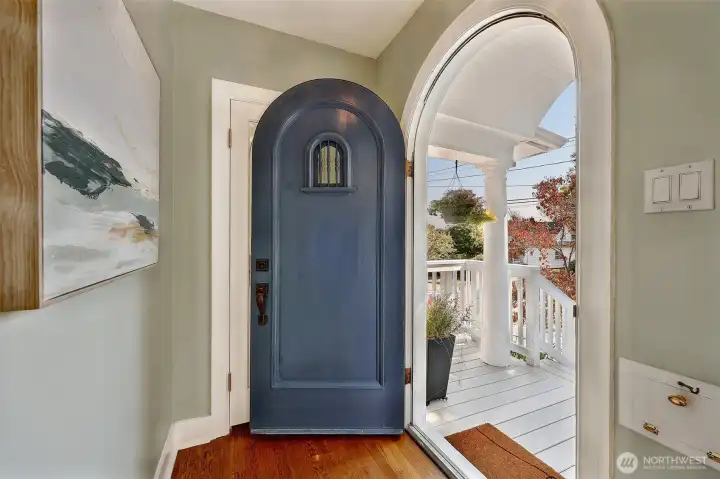 Arched door and doorway are a classic treatment. Closet with window behind the door completes the setting.