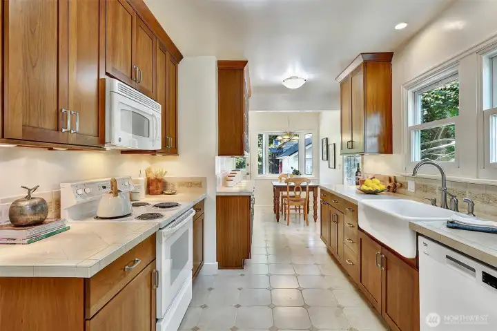 This well-lit kitchen is a highlight, featuring a generously sized breakfast nook that seamlessly connects to the property's rear deck, creating an inviting space for meals and outdoor enjoyment.