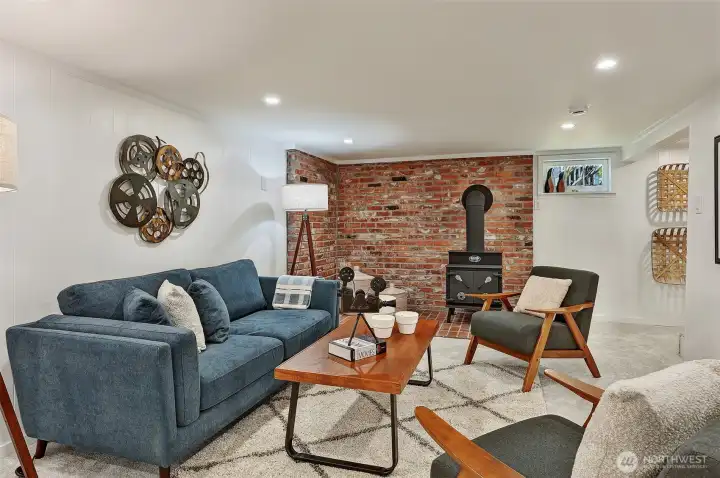 Lower level rec room features wood burning stove, new carpet, and plenty of space for fun.