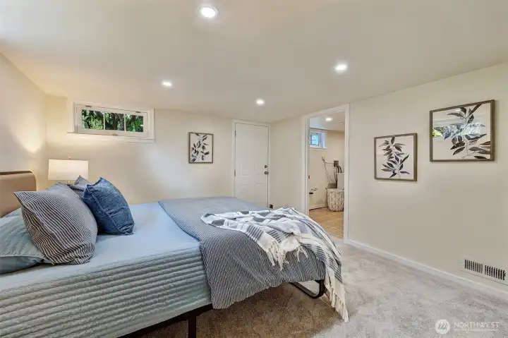 Lower Level bedroom, view to rear door and laundry room.