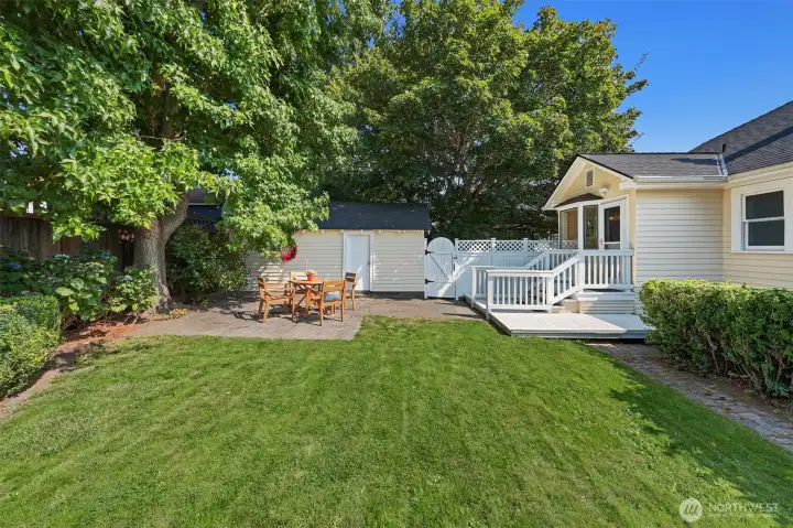 Backyard view including garage, rear deck, and patio.