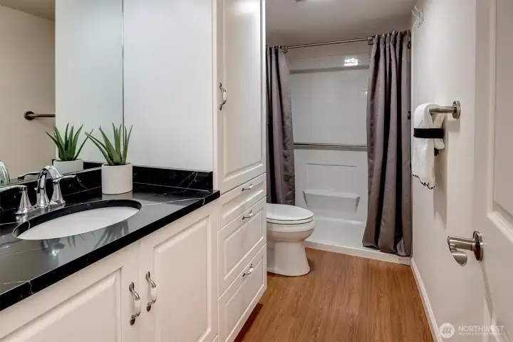 Guest bathroom is located around the corner from the guest bedroom.