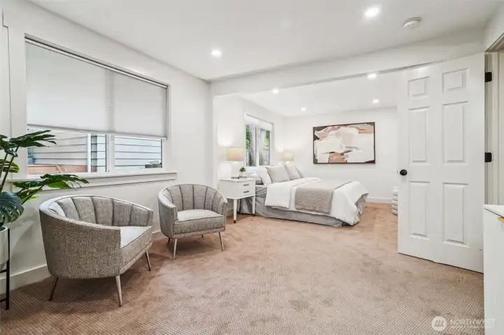 The main floor primary suite is impressively spacious, with room for a king-sized bed and a seating area!