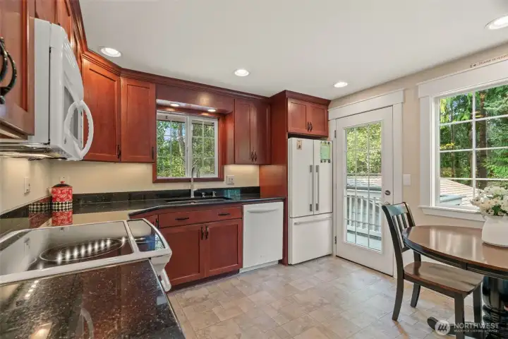 Kitchen with granite counters, eating nook and access to the rear deck.